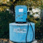 A blue gas pump sitting on a pallet