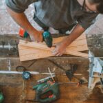 A Man Drilling Hole on a Wood