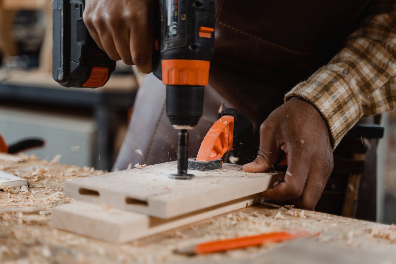 Carpenter Drilling a Wood